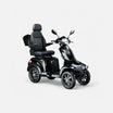 GoVida IVA S1000 Zwart scootmobiel parked on a pathway, showcasing its sleek black design and comfortable seating.